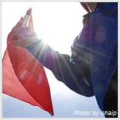 man holding red flag